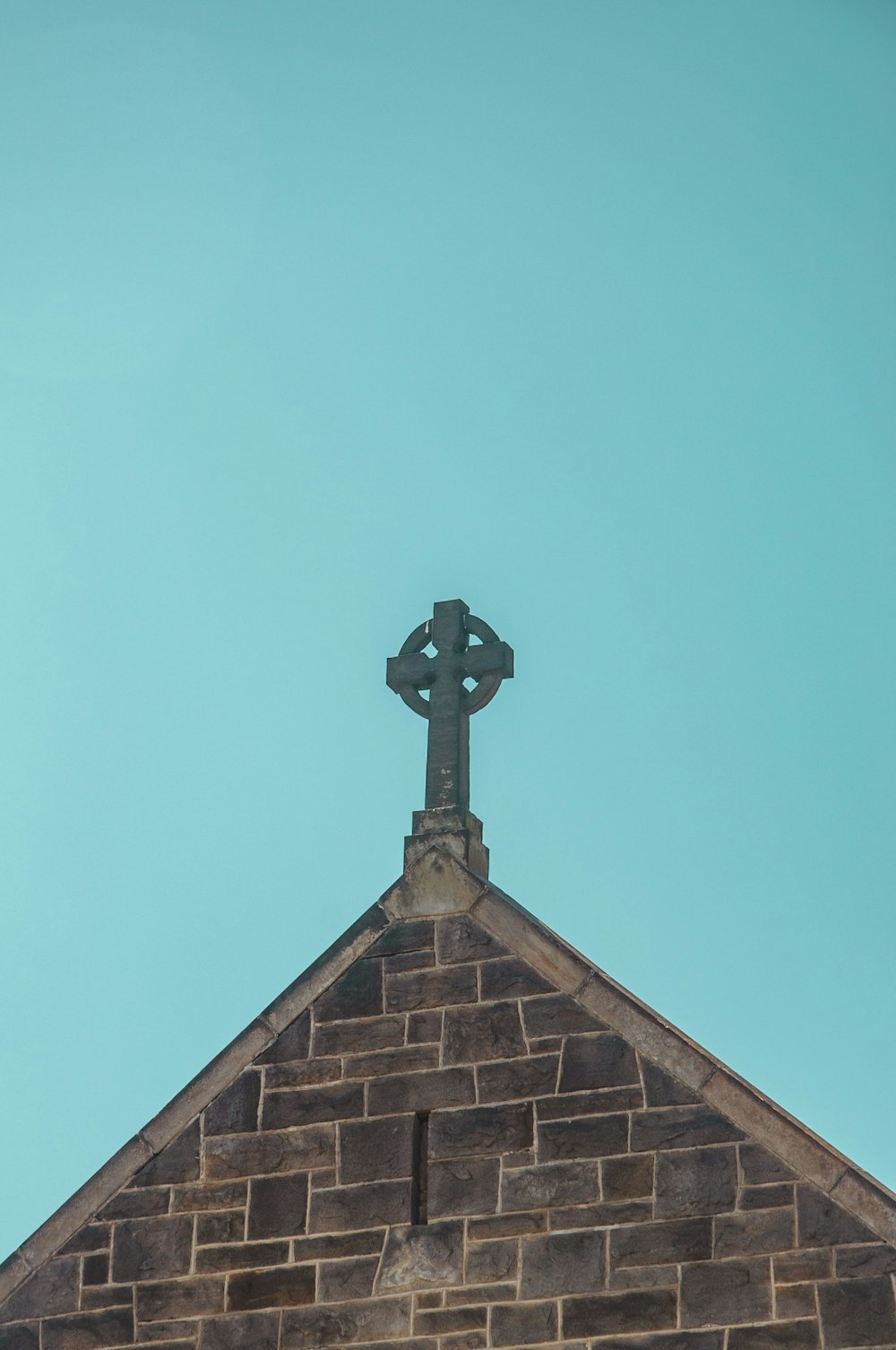 brown brick church under clear blue sky