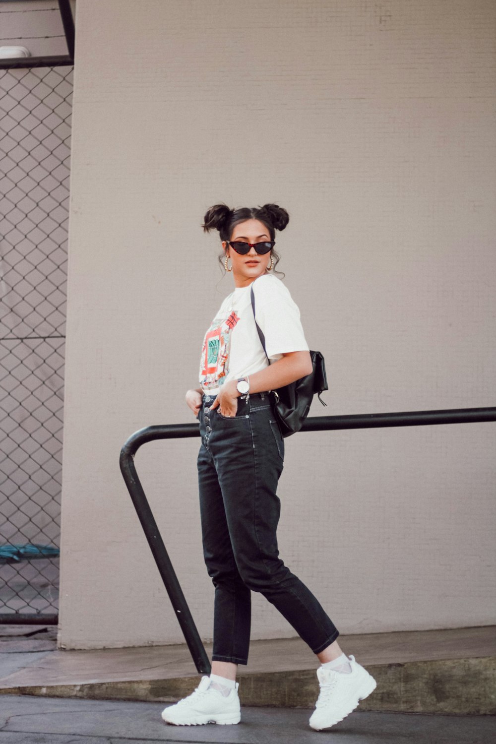 woman wearing black pants and white shoes