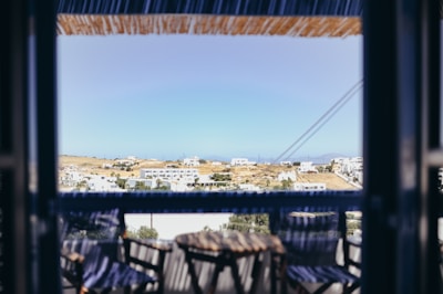 Scenic mountain view from a hotel balcony with cozy chairs