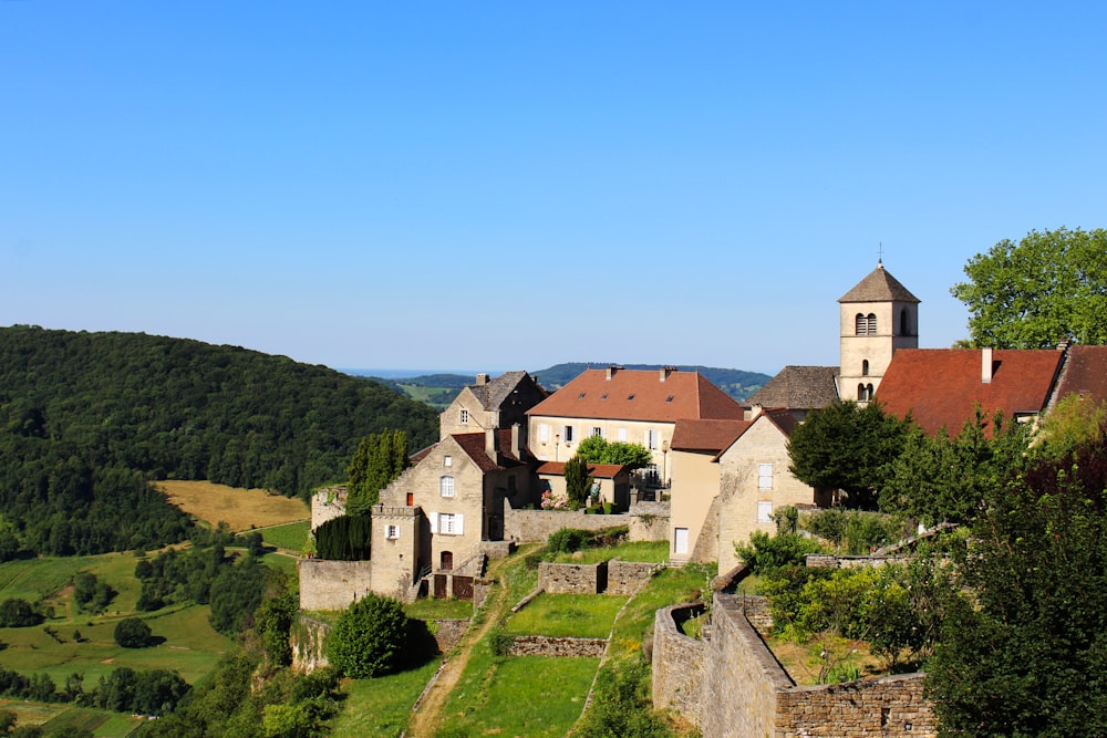 a castle with a steeple on top of a hill