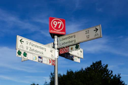 a street sign on a pole in front of a blue sky