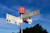 a street sign on a pole in front of a blue sky