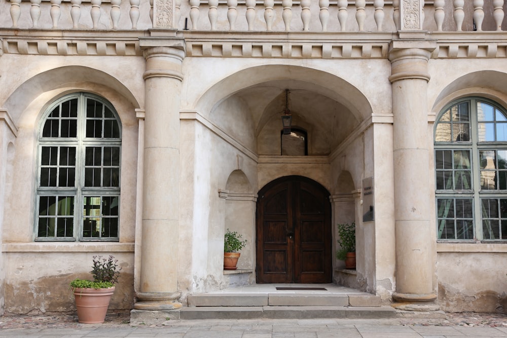 a large stone building with arched windows and a wooden door