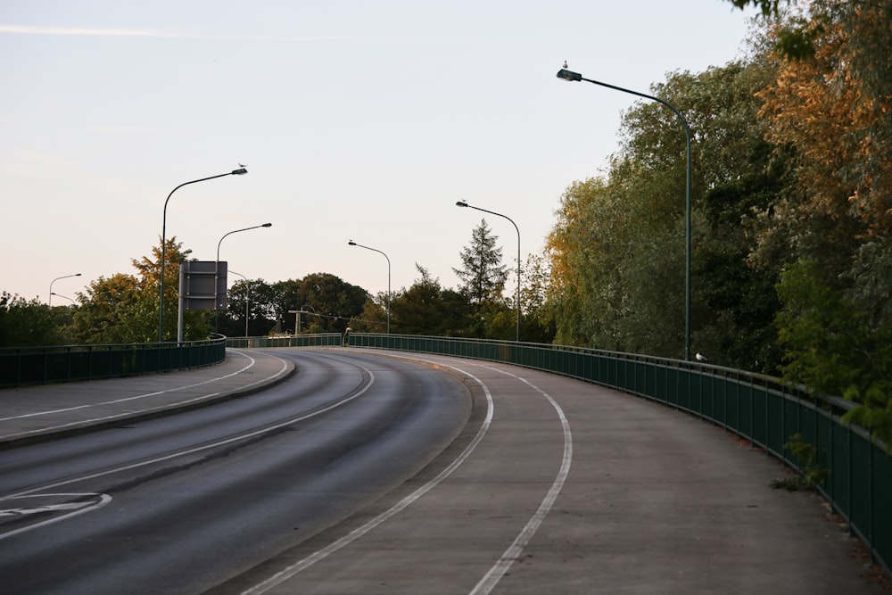 a curved road with street lights on either side