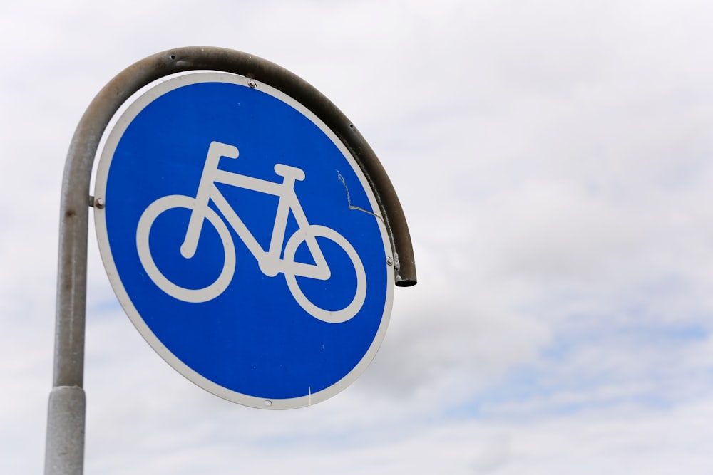 un cartello stradale blu con una bicicletta su di esso