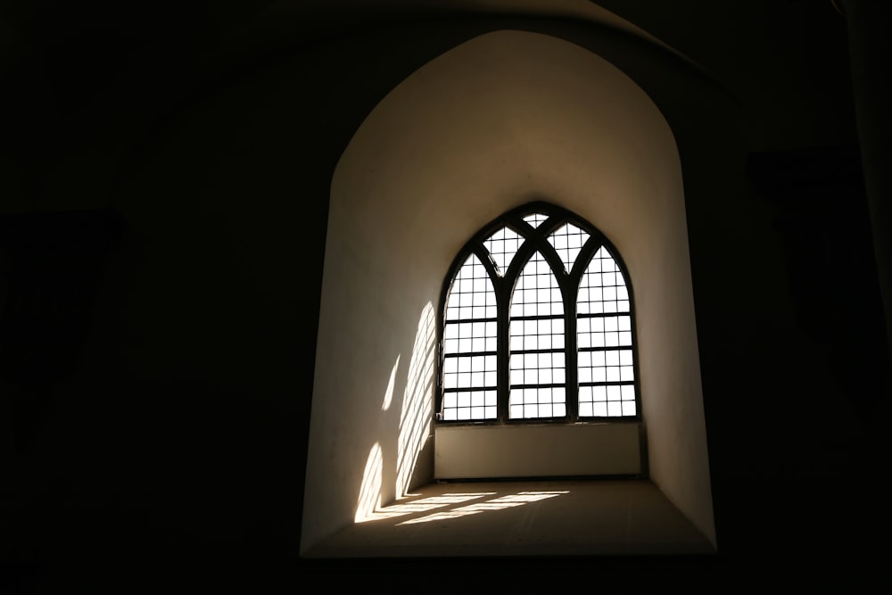 a window in a building with a light coming through it