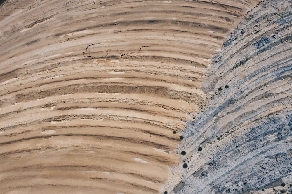 a close up of a dirt hill with a sky background