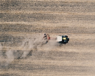 An aerial view of a John Deere tractor working on a farm.