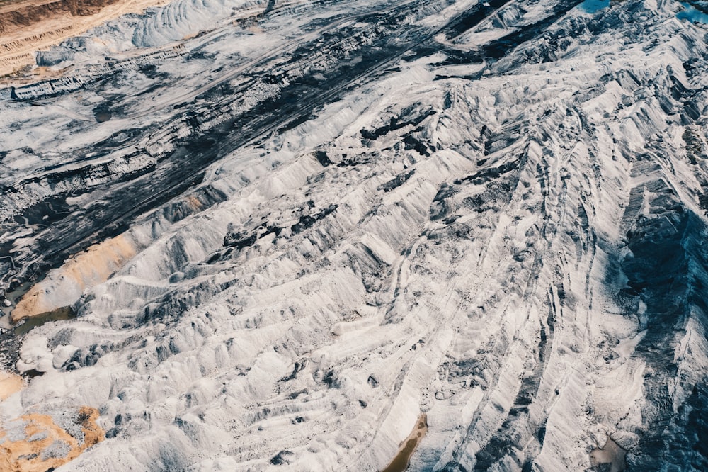 an aerial view of a large glacier with mountains in the background