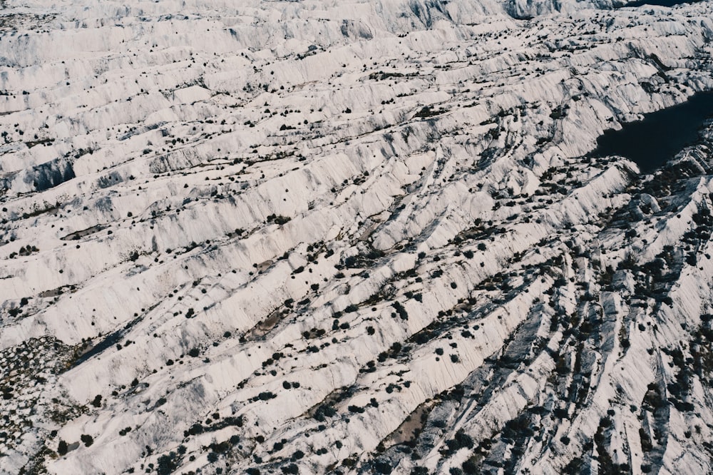 an aerial view of a rocky area covered in snow