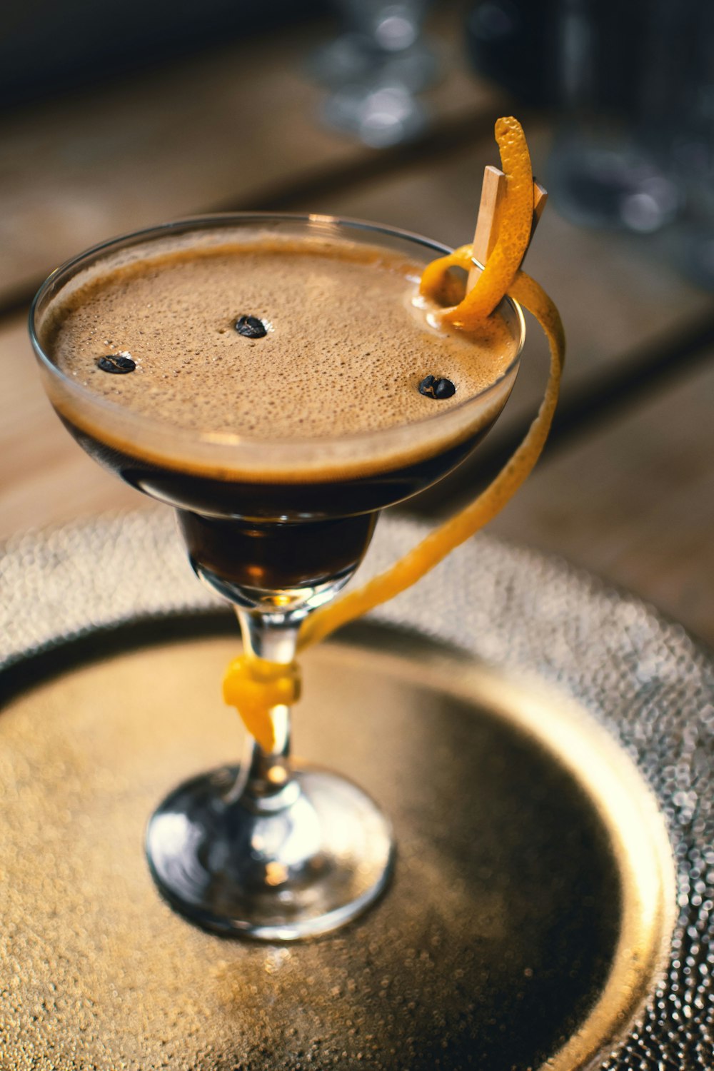 clear margarita glass with brown liquid