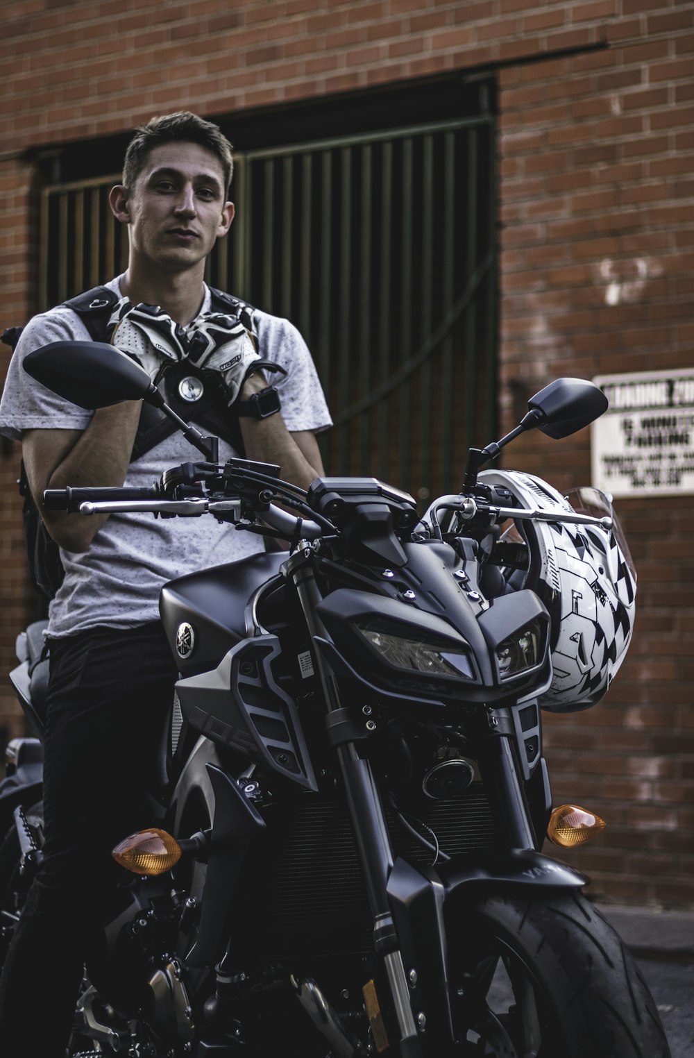 man riding on black motorcycle close-up photography