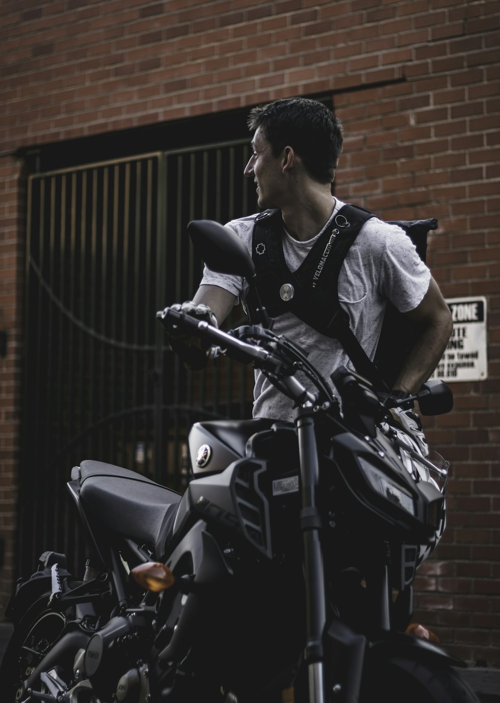 man standing beside motorcycle