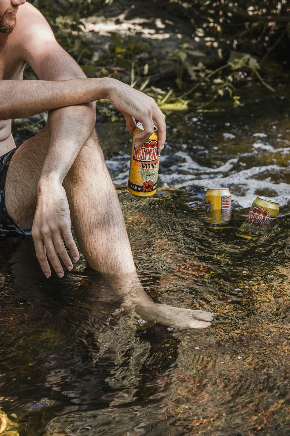 person holding yellow drinking can