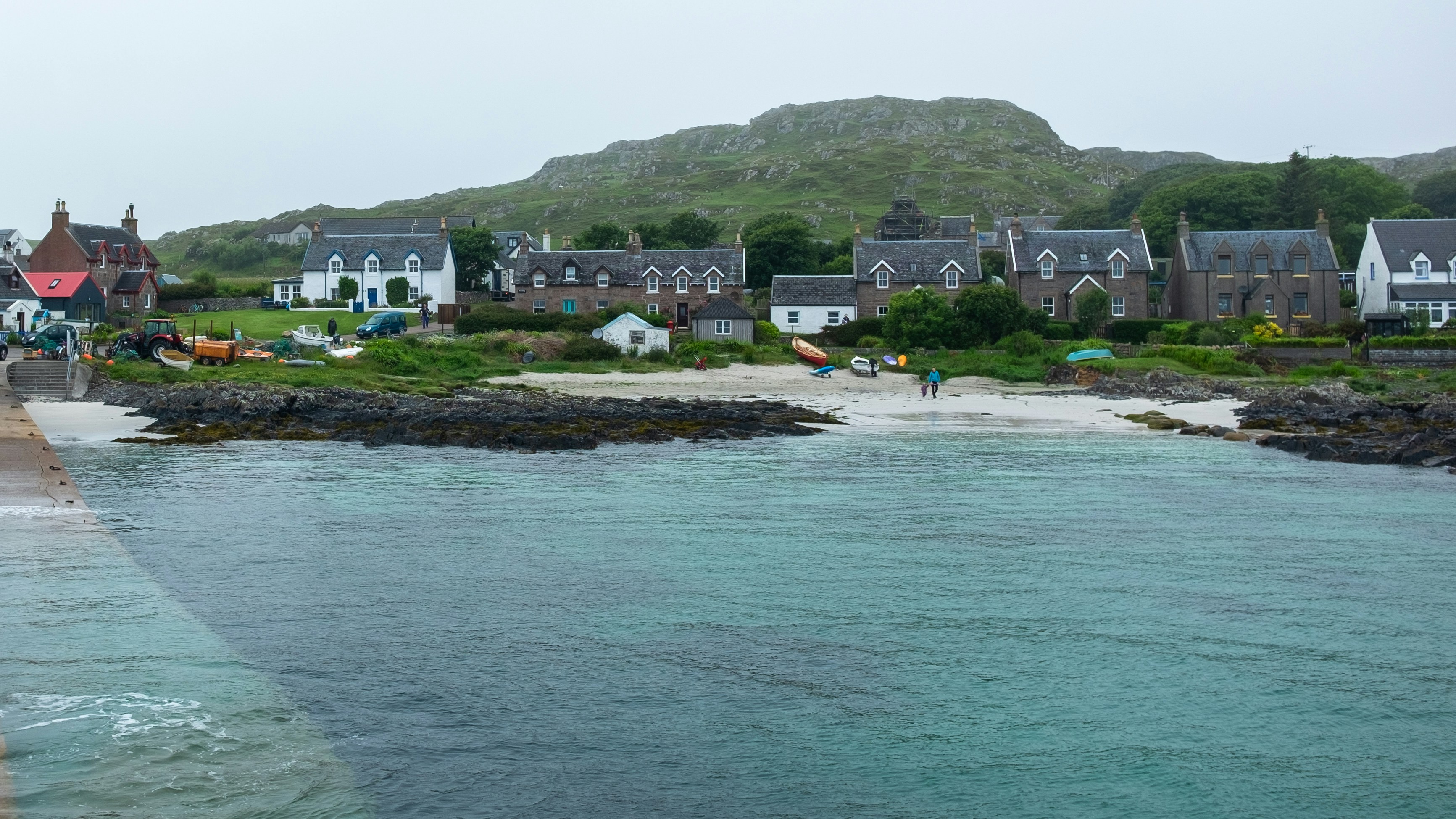 body of water near black and white houses at daytime