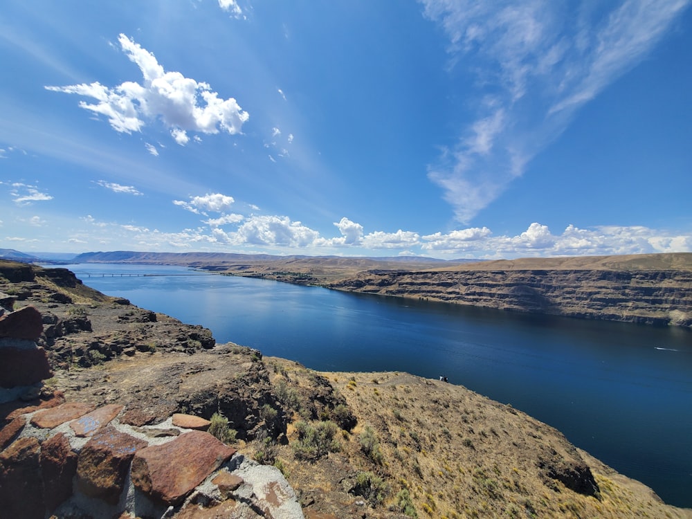 rock formations beside body of water at daytime