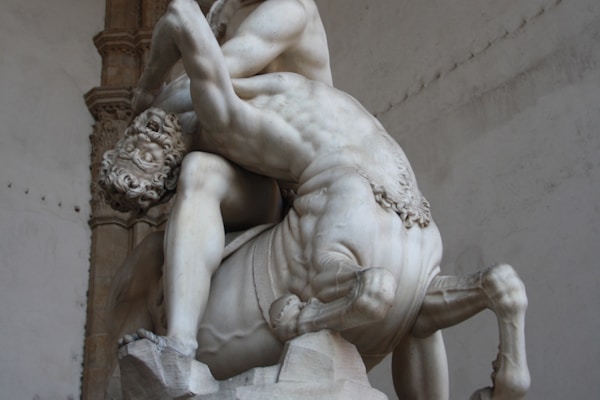 man fighting centaur statue