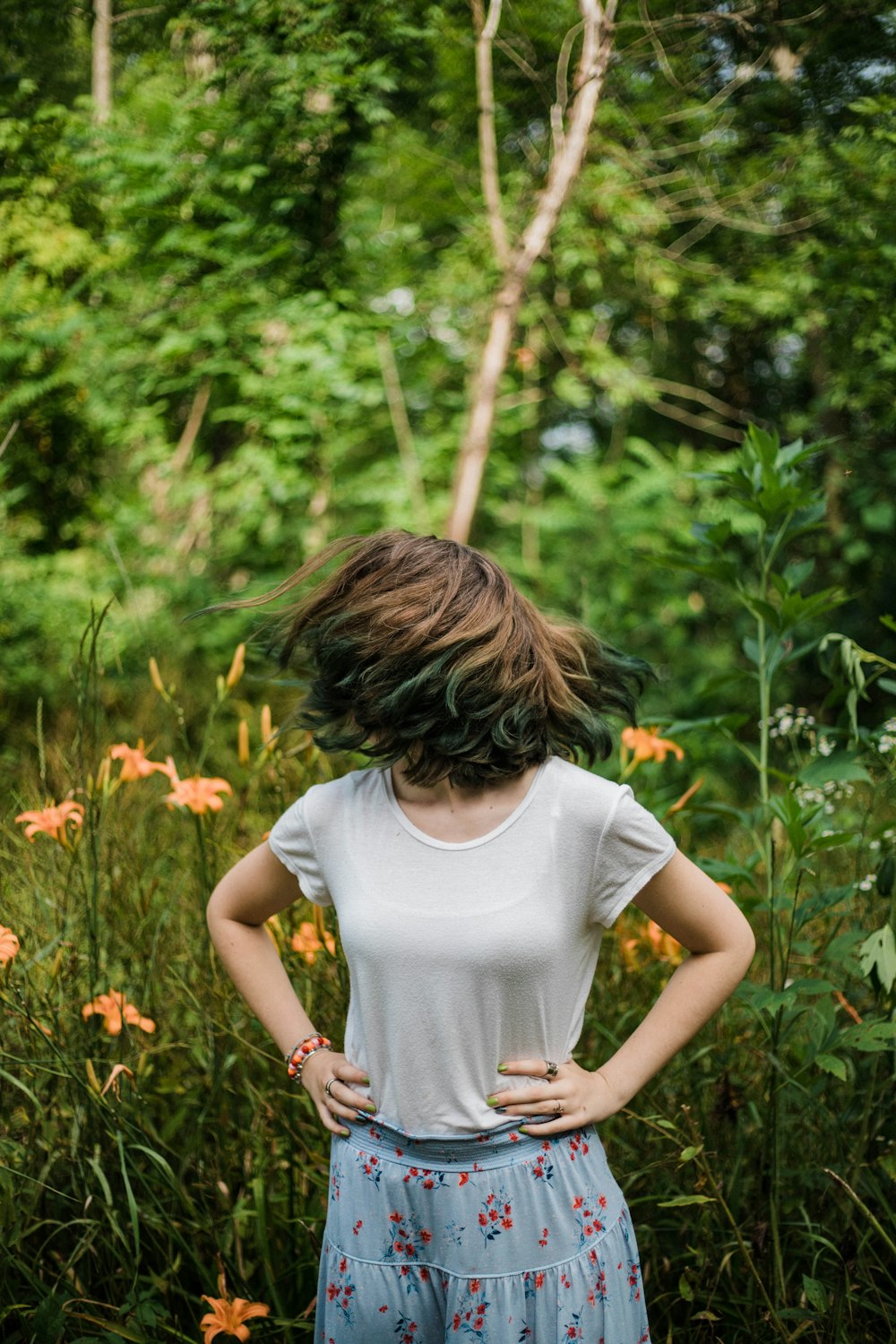 woman wearing white shirt holding her waist