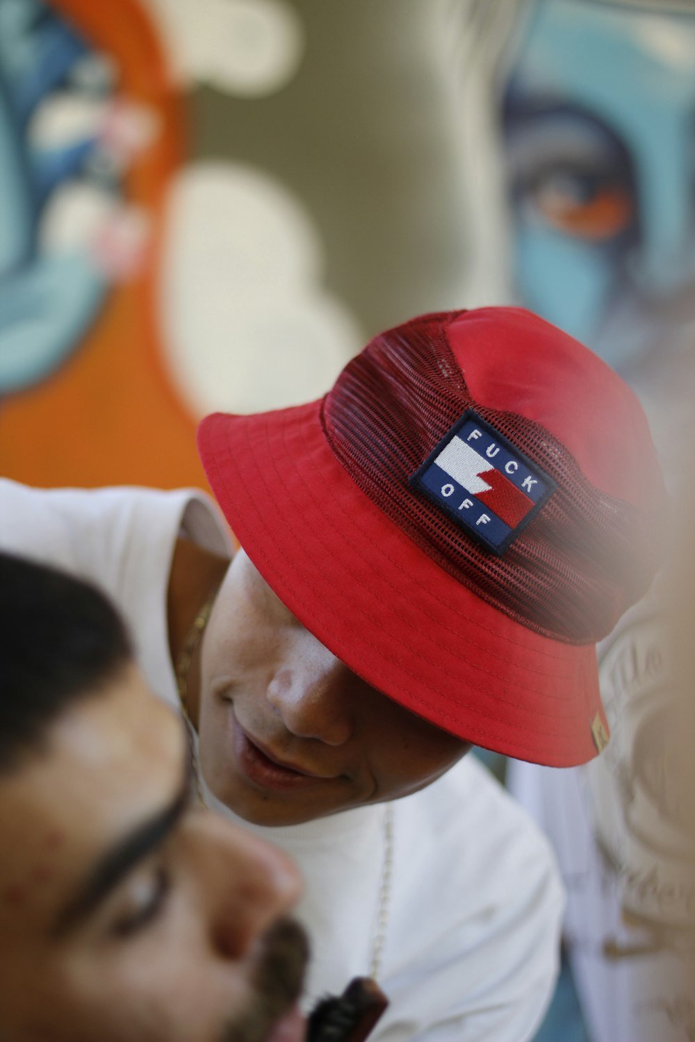 man wearing red bucket hat and white shirt