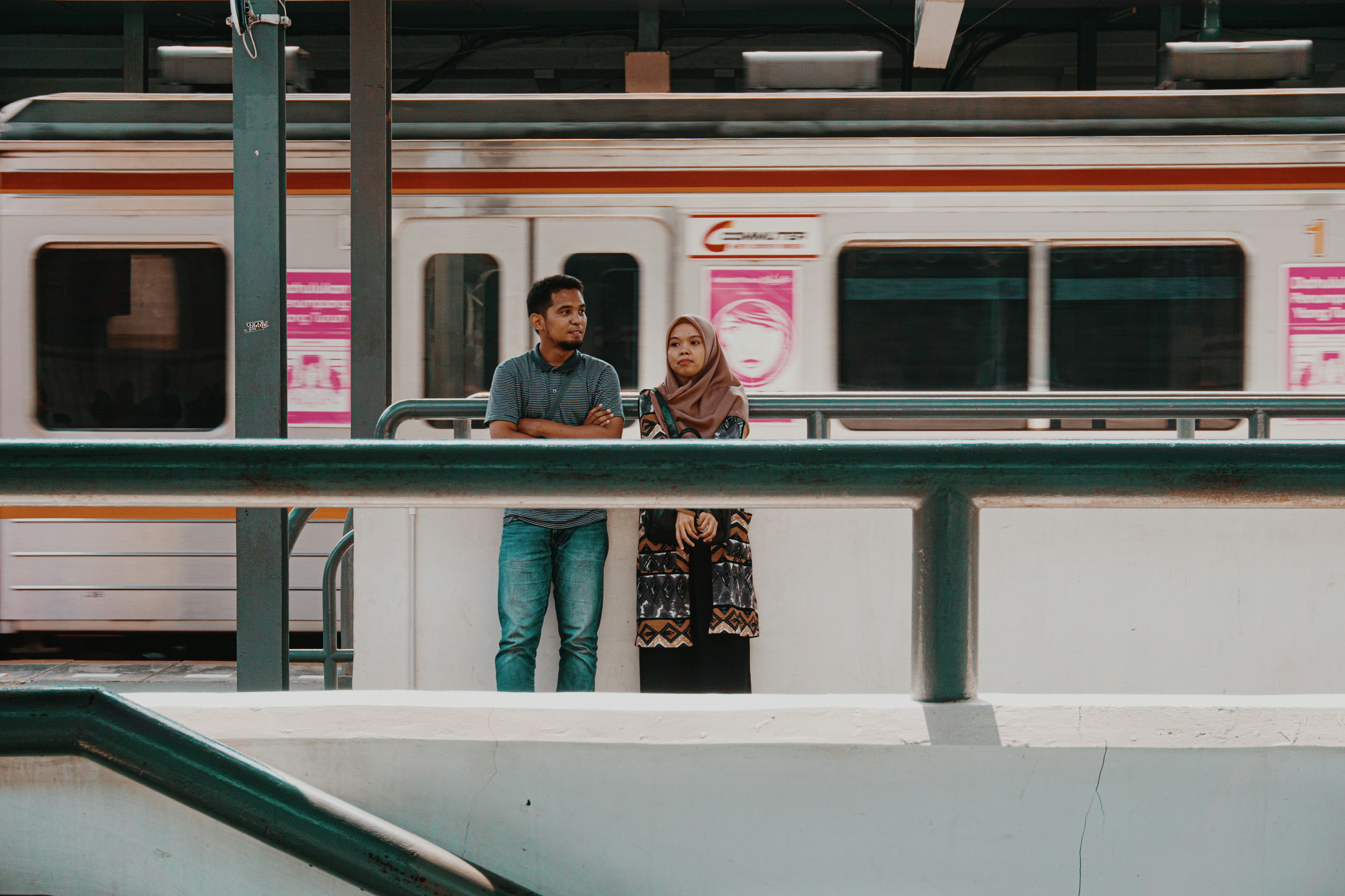 man and woman standing near train
