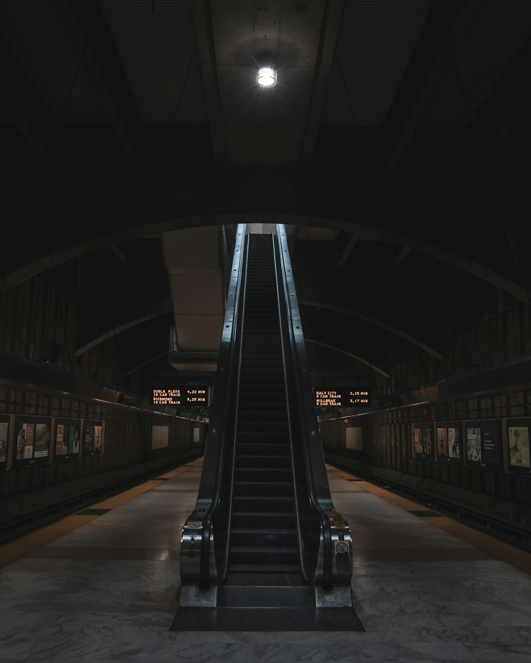 gray and black escalator inside brown building