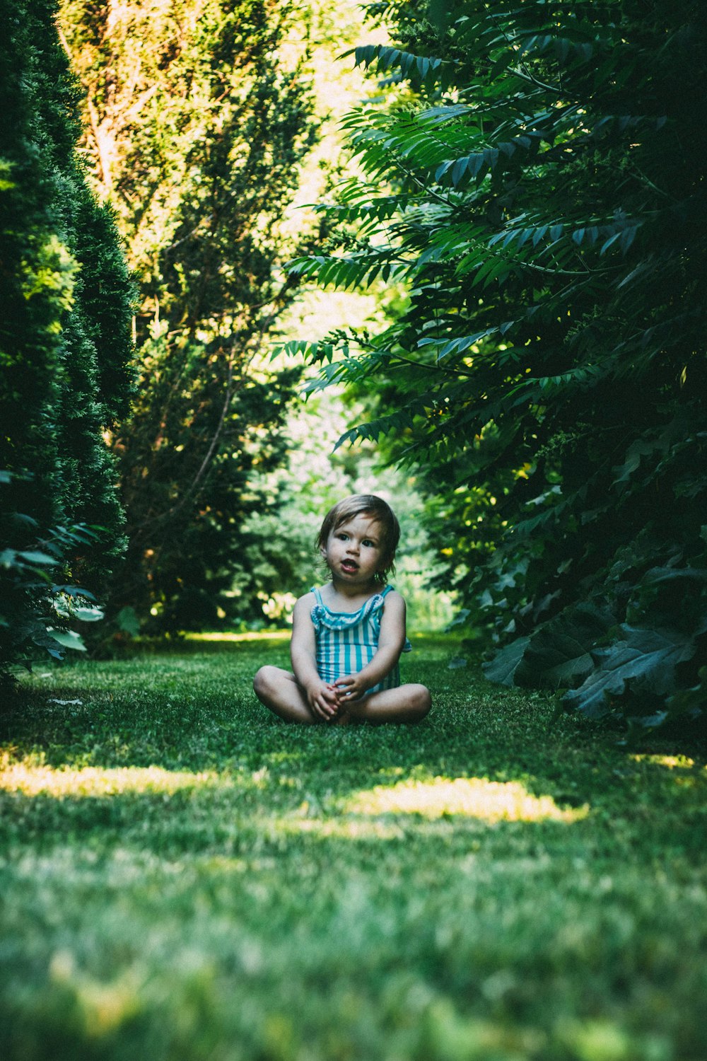 girl sitting on green grass