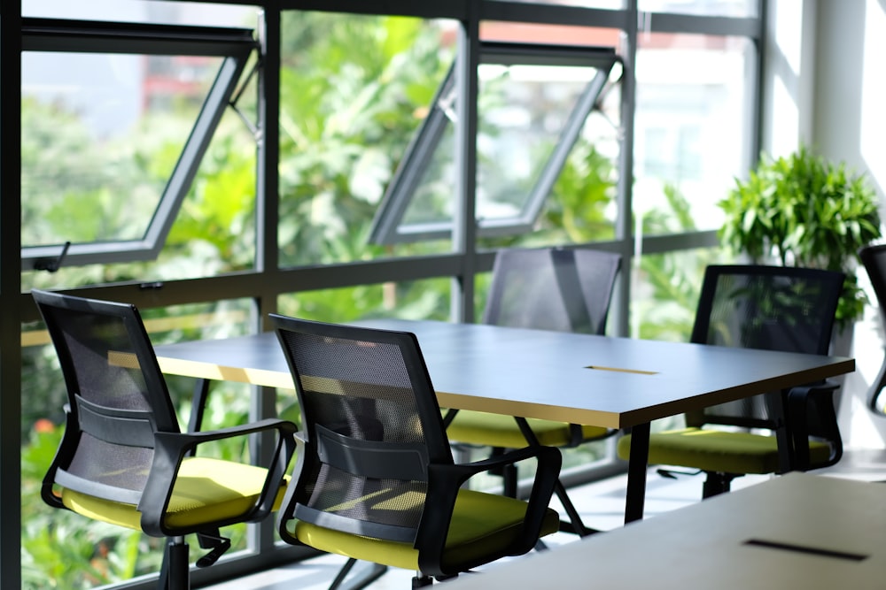 empty black and green armchairs beside table