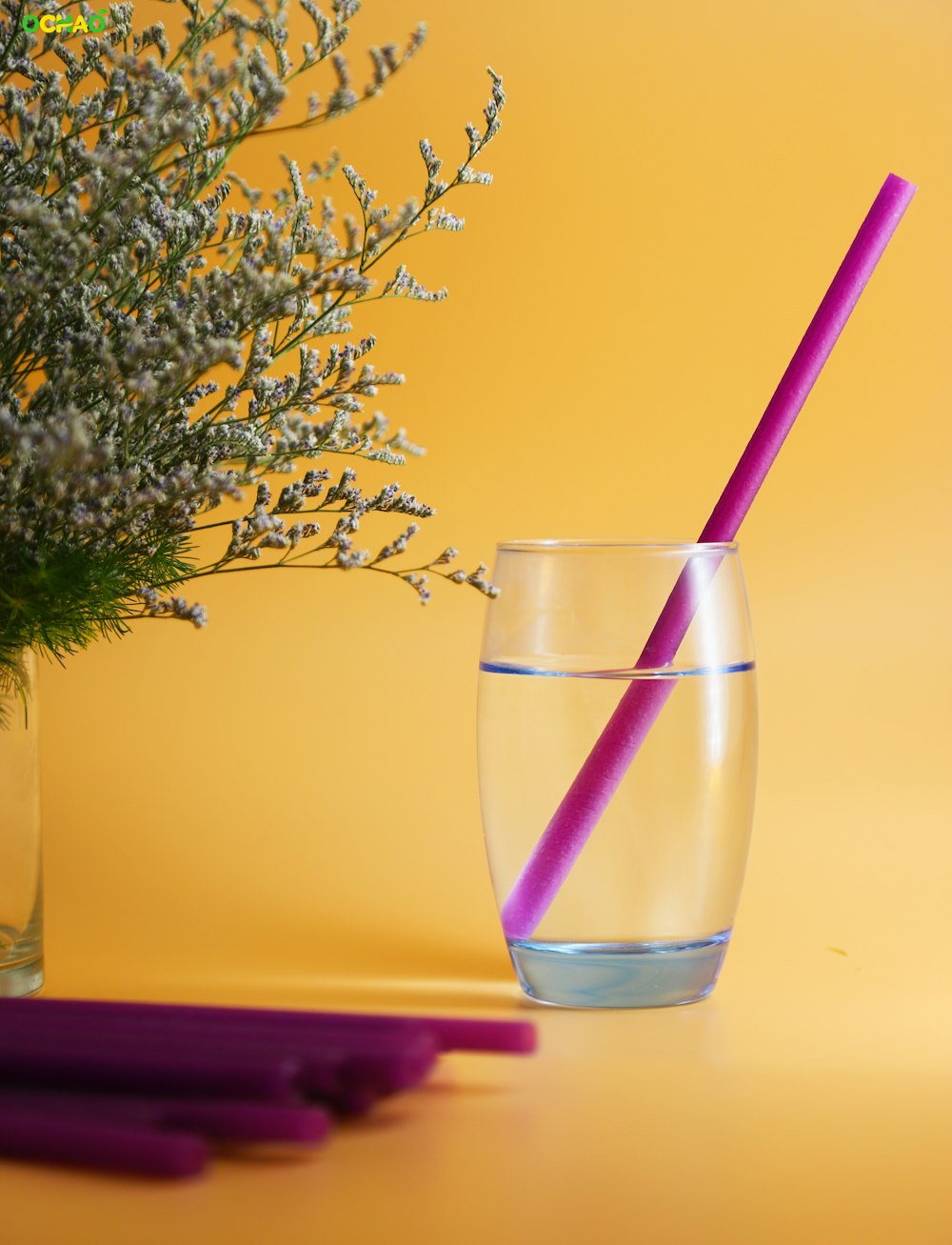 water in drinking glass with pink straw