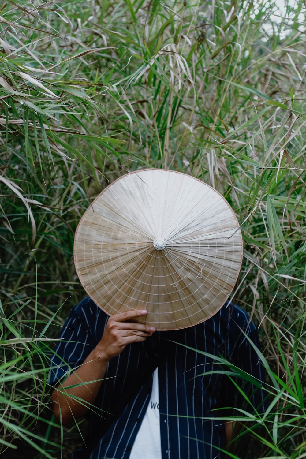 man holding brown hat