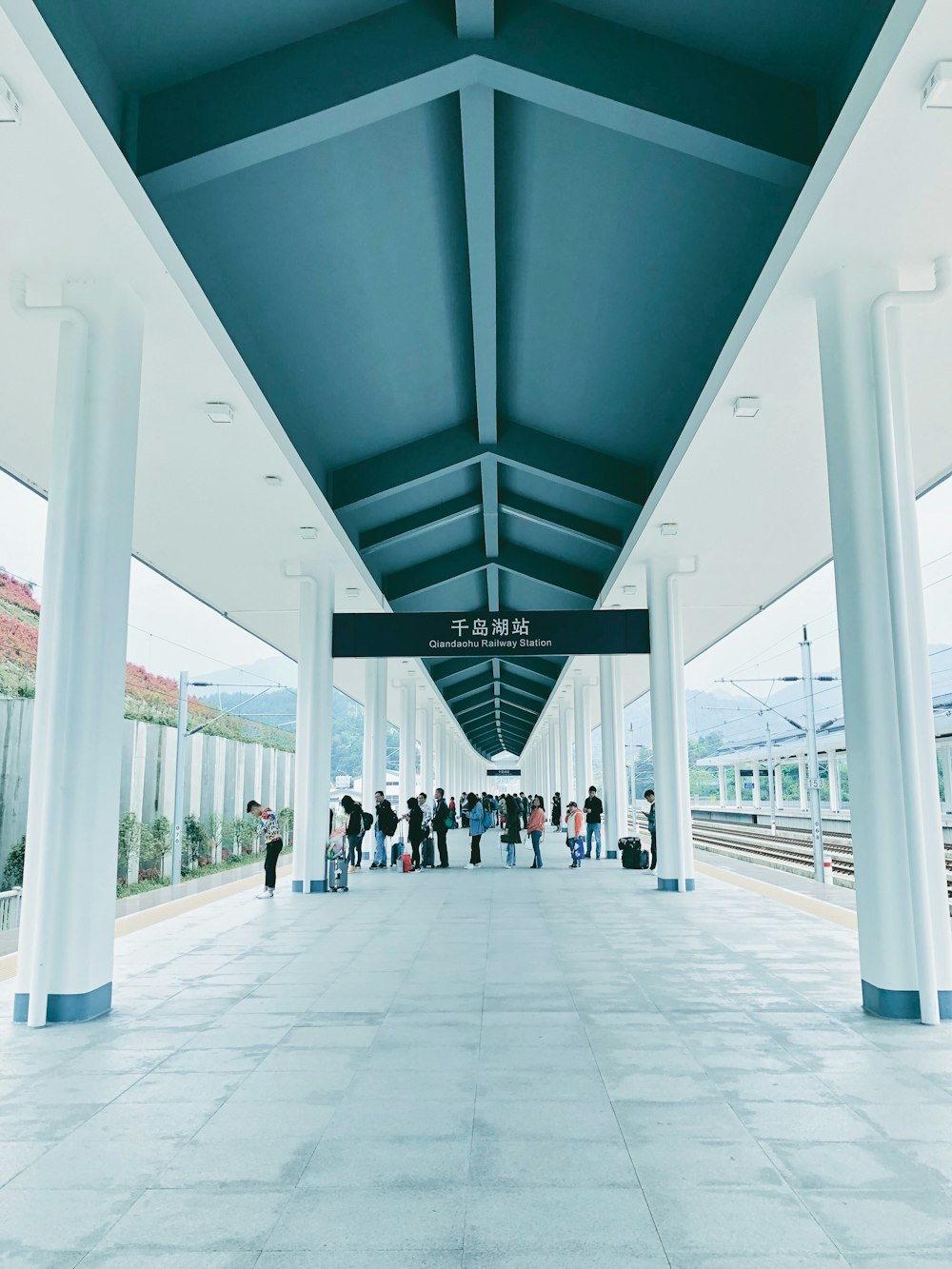 people standing near train station during daytime