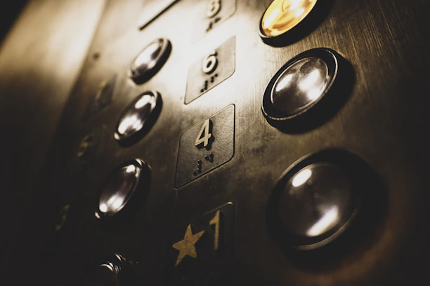 Close-up of a modern elevator panel with polished buttons and sleek design.
