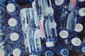 Stack of custom-labelled water bottles ready for delivery