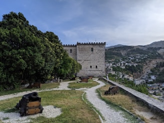 Historic stone fortress overlooking a lush green valley in Georgia.