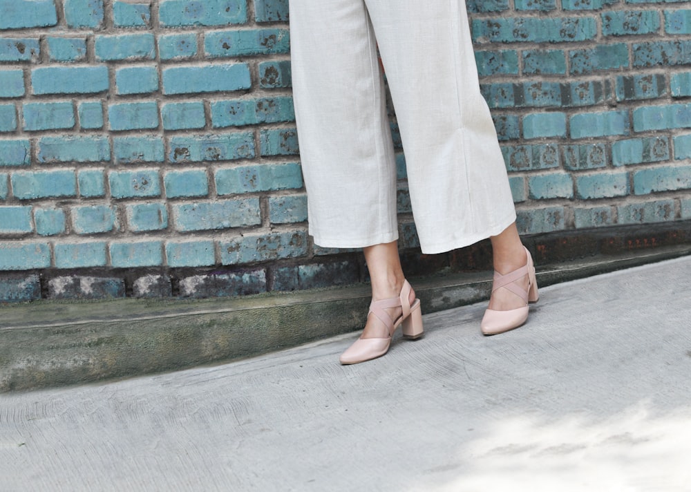 woman wearing gray pants and brown sandals
