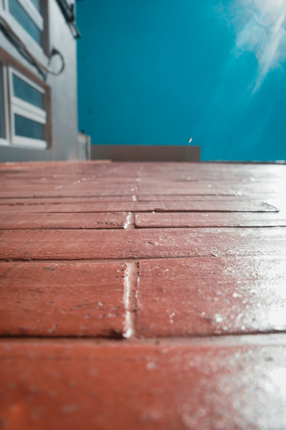 red bricked floor near blue painted wall