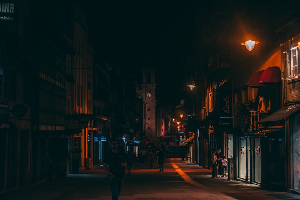 people walking on street during nighttime