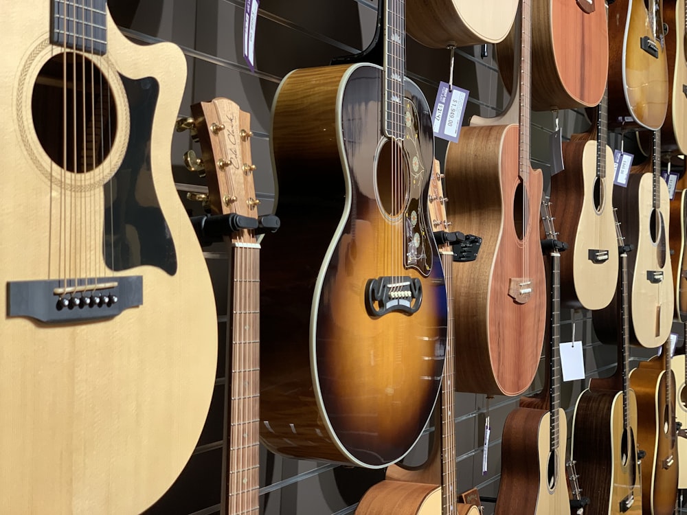 closeup photo of hanged guitars