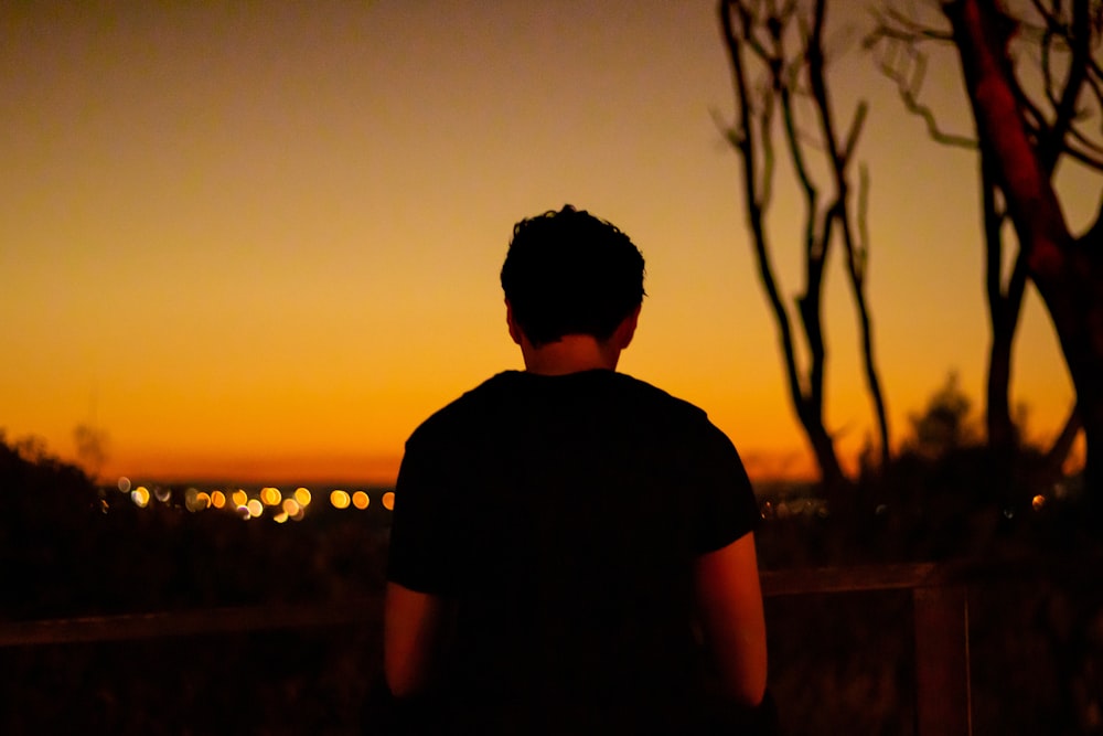 man standing outside during golden hour