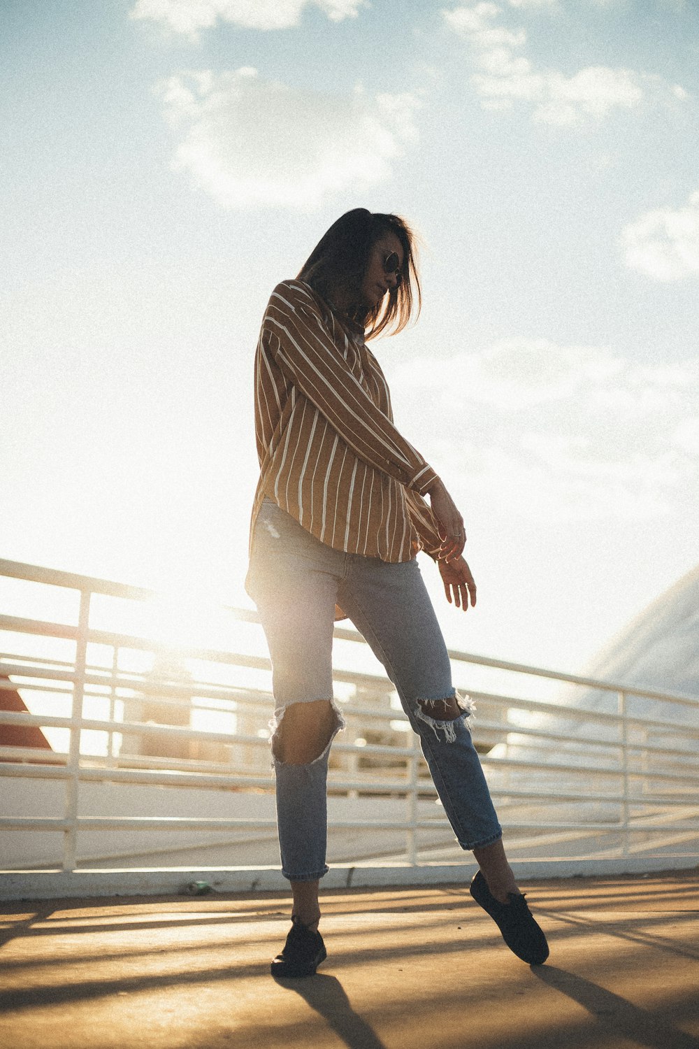 woman in brown and white striped long-sleeved shirt