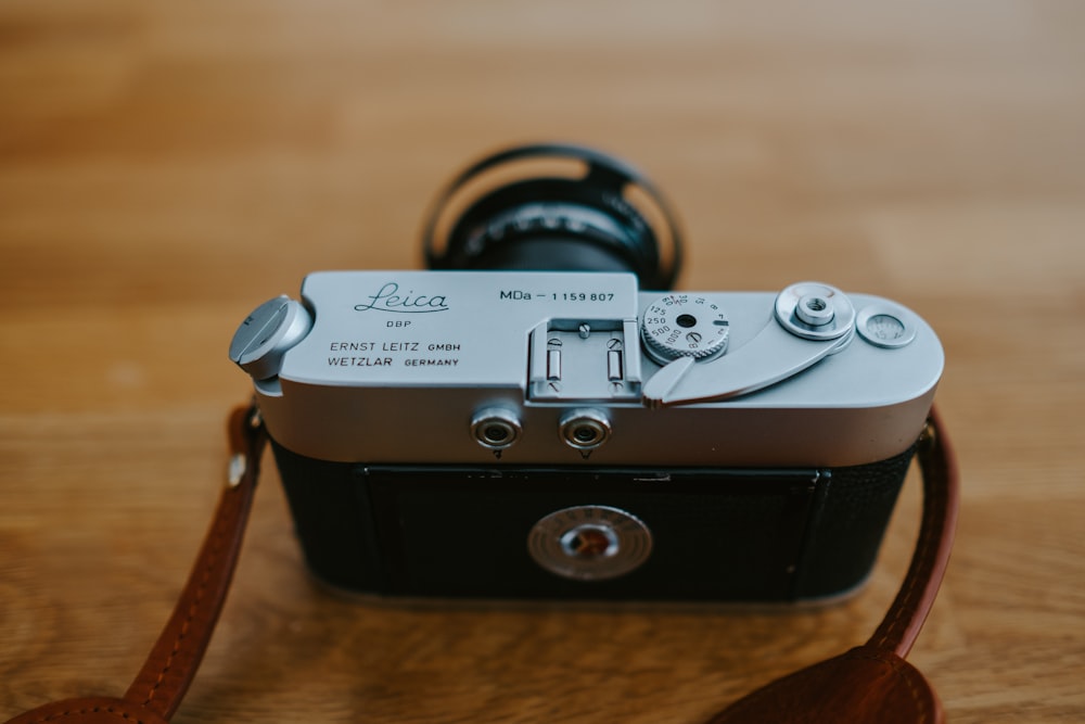 black and gray camera on brown surface