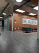 a large room with a brick wall and chairs