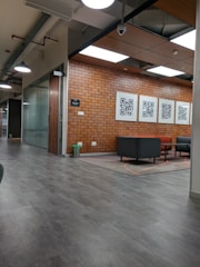 a large room with a brick wall and chairs