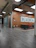 Modern, sleek container office setup with maroon accents, situated in a bustling industrial area in Qatar.