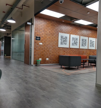 a large room with a brick wall and chairs