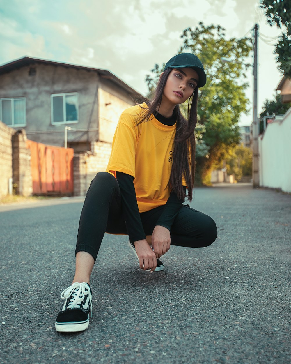 woman wearing yellow shirt and black pants