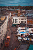 Vibrant street scene in London with travelers exploring local markets.