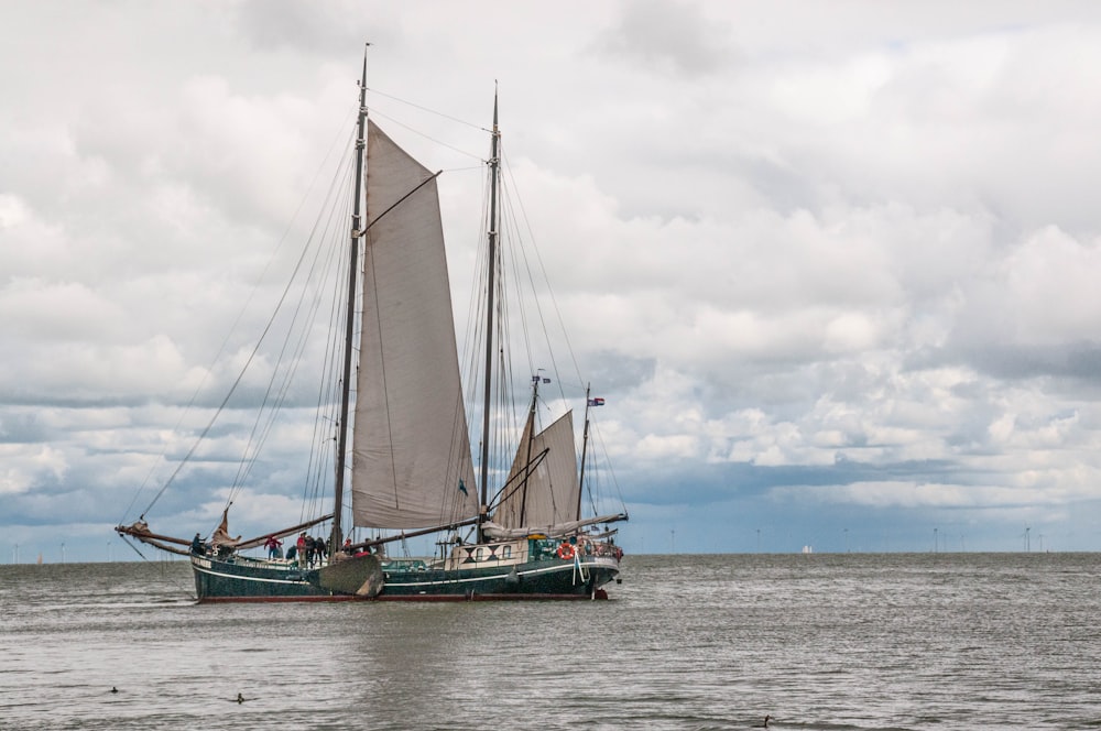 white and teal boat