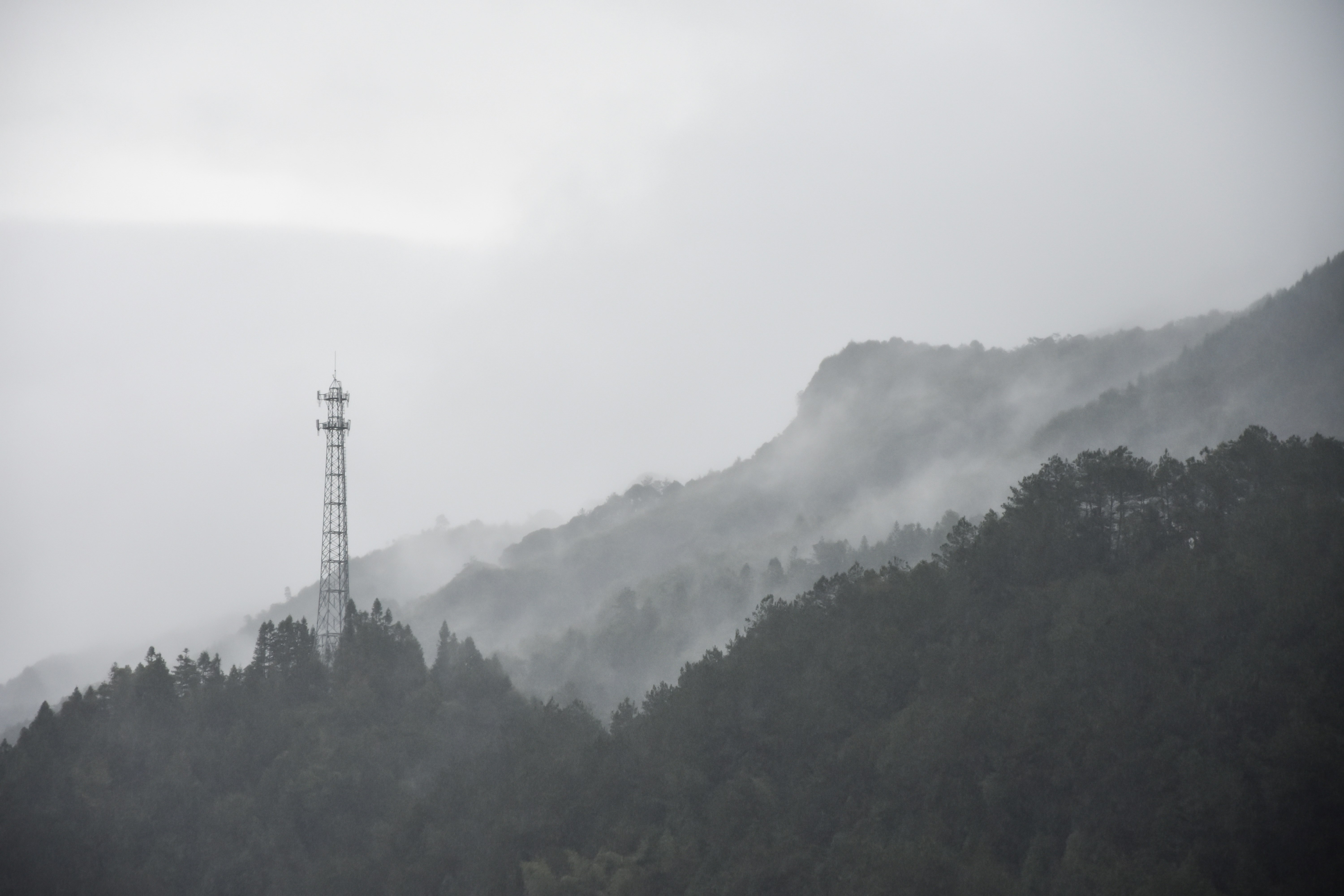 tower on hill covered with fog