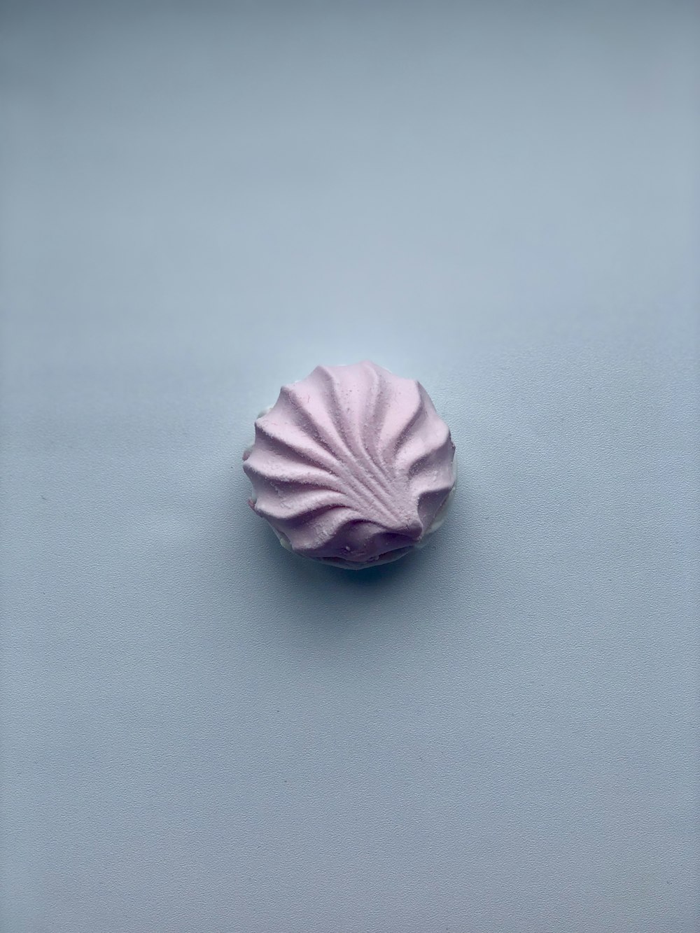 a pink object on a blue background