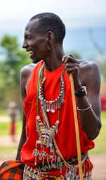 smiling man standing and facing his right side